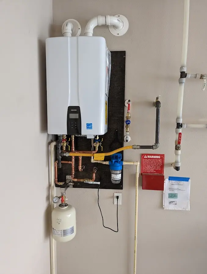 Professional plumber installing copper piping in a Rosemount home